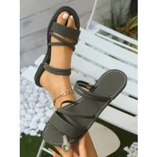 Women's plus size black sandals with flip-toe buckle and cross straps on flat rubber sole