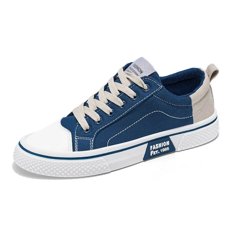 Men's low-top blue canvas shoes with round toe and white stitching on a soft PVC sole.
