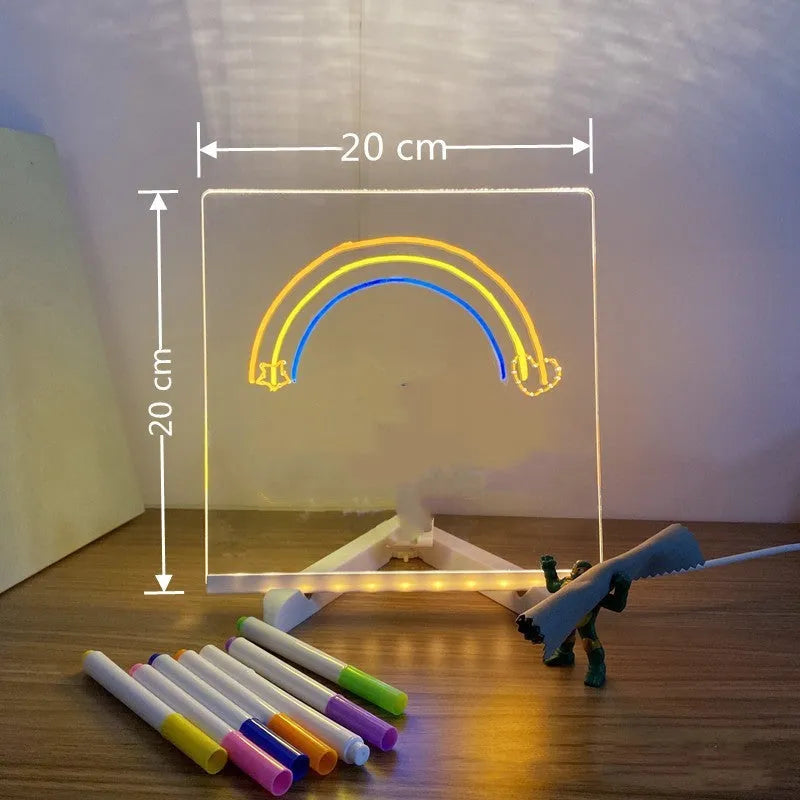 Acrylic DIY LED message board night light on a desk with handwritten drawing glowing softly.
