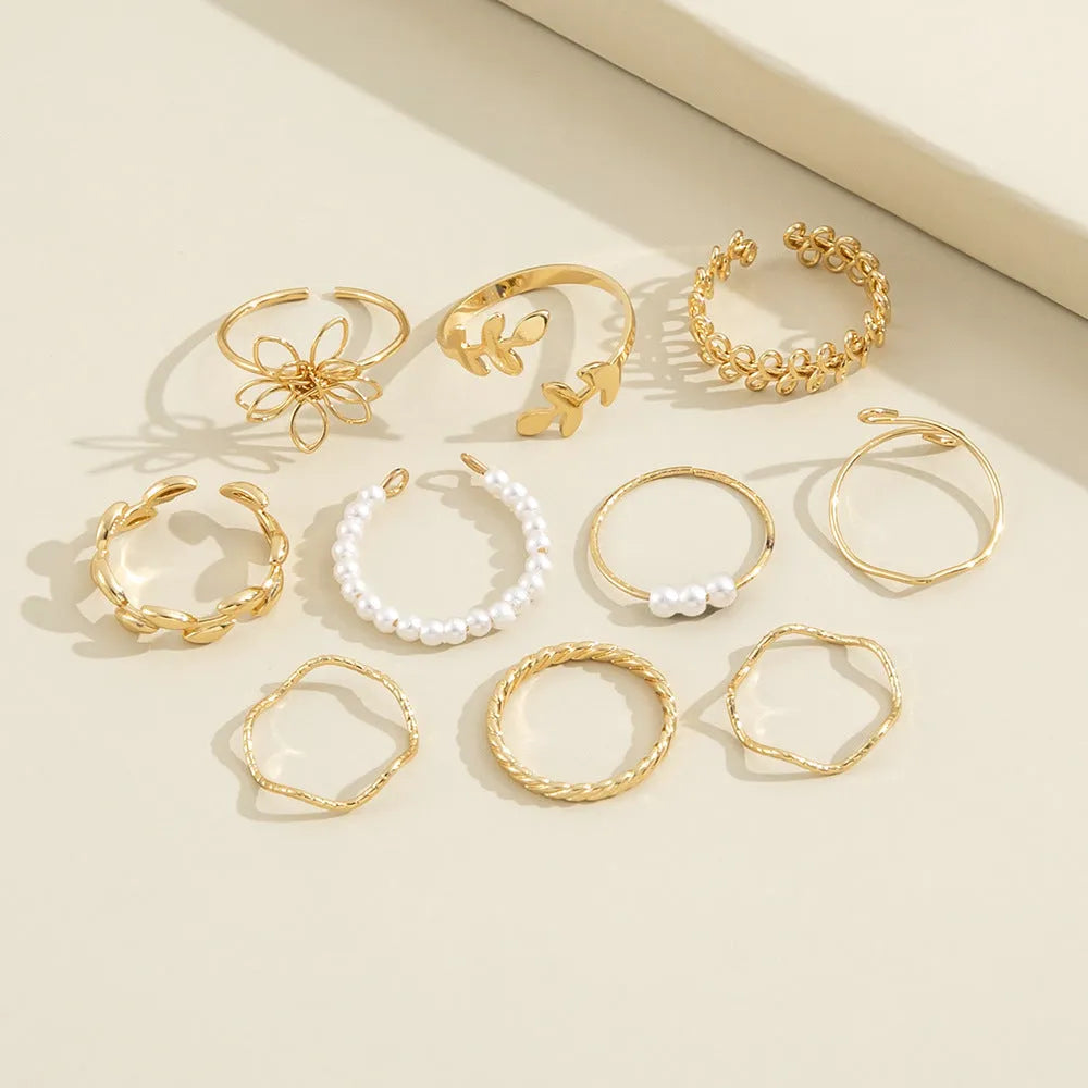 Gold openwork flower ring with delicate floral design and glossy electroplated finish