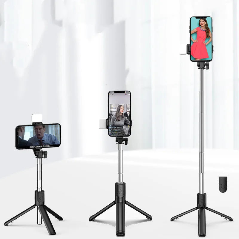 Black Bluetooth selfie stick with integrated tripod legs extended, showing 360-degree rotation mechanism and phone holder
