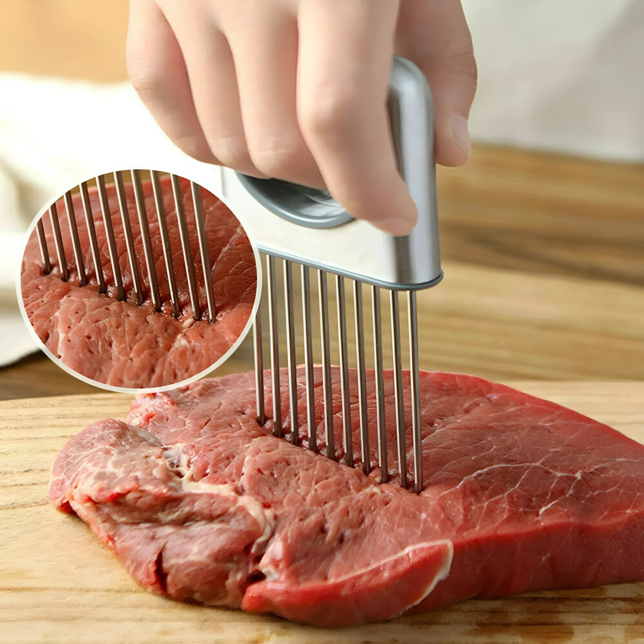 Stainless steel onion holder slicer with sharp prongs and a red finger guard on a kitchen counter.