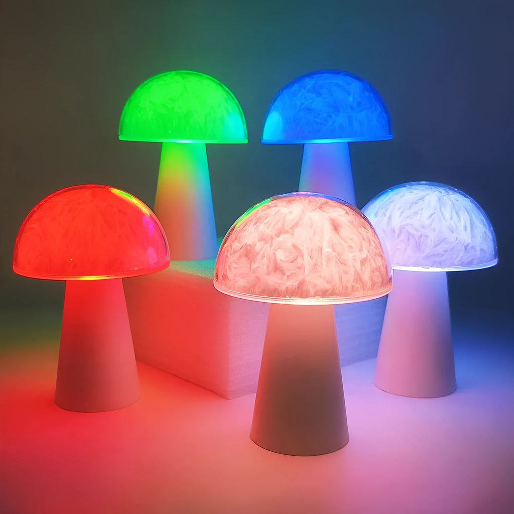 Colourful mushroom-shaped night lamp with remote control on a wooden surface.
