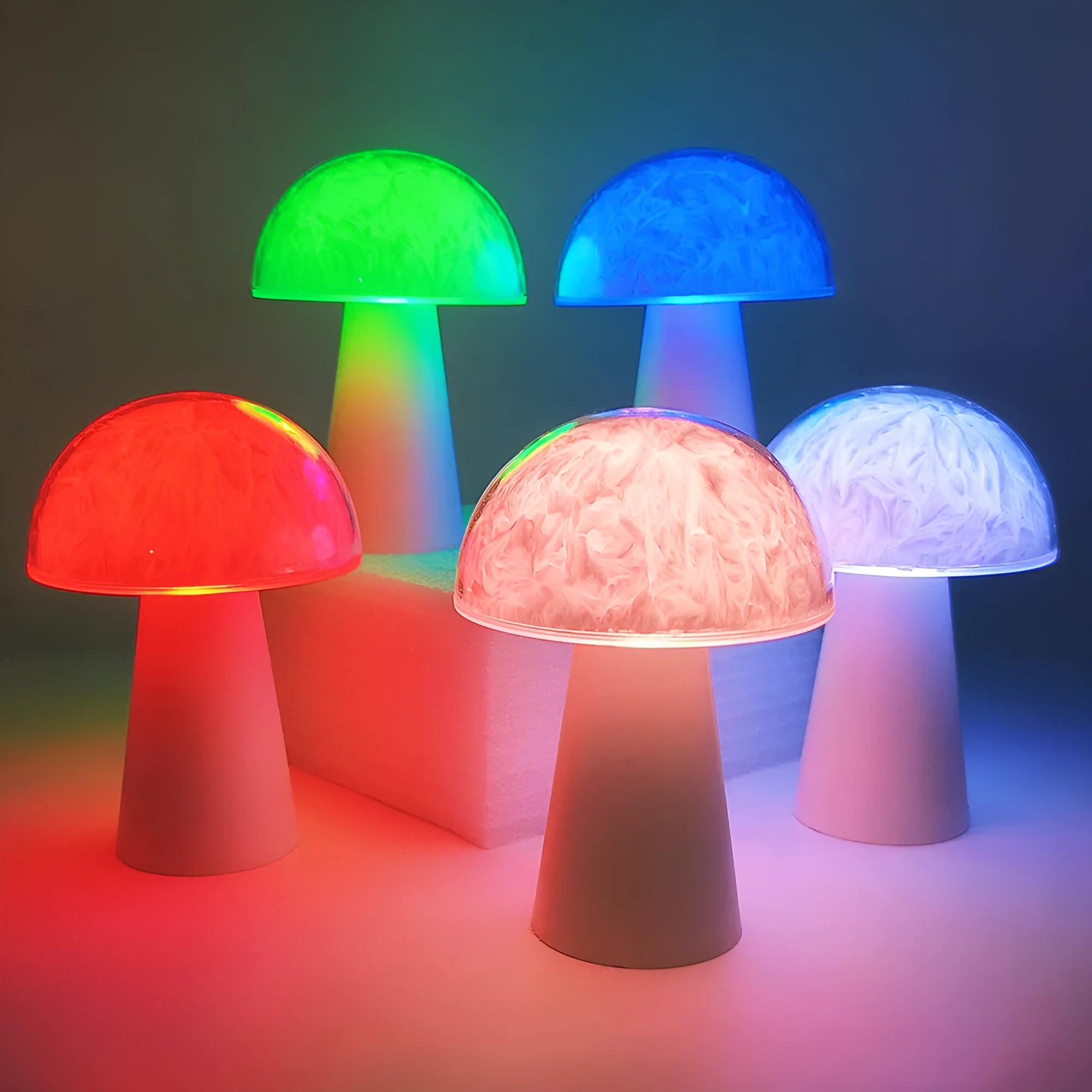 Colourful mushroom-shaped night lamp with remote control on a wooden surface.