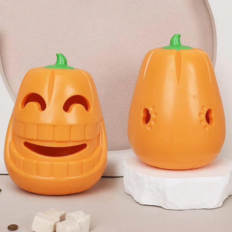 Orange Halloween pumpkin-shaped dog chew toy with treat-dispensing openings and textured surface