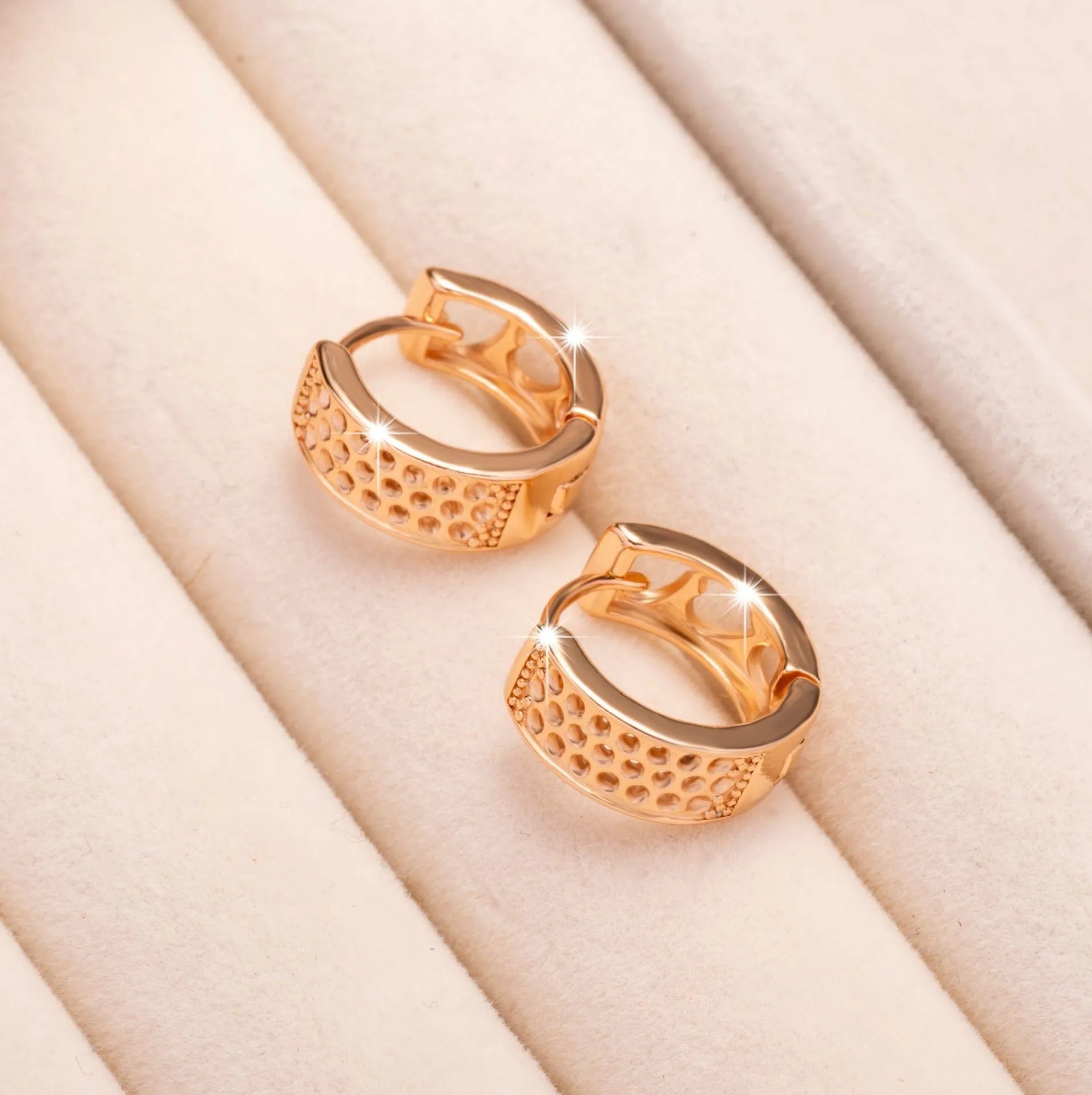 Rose gold hollowed-out heart earrings with circular 2.5cm diameter on white background