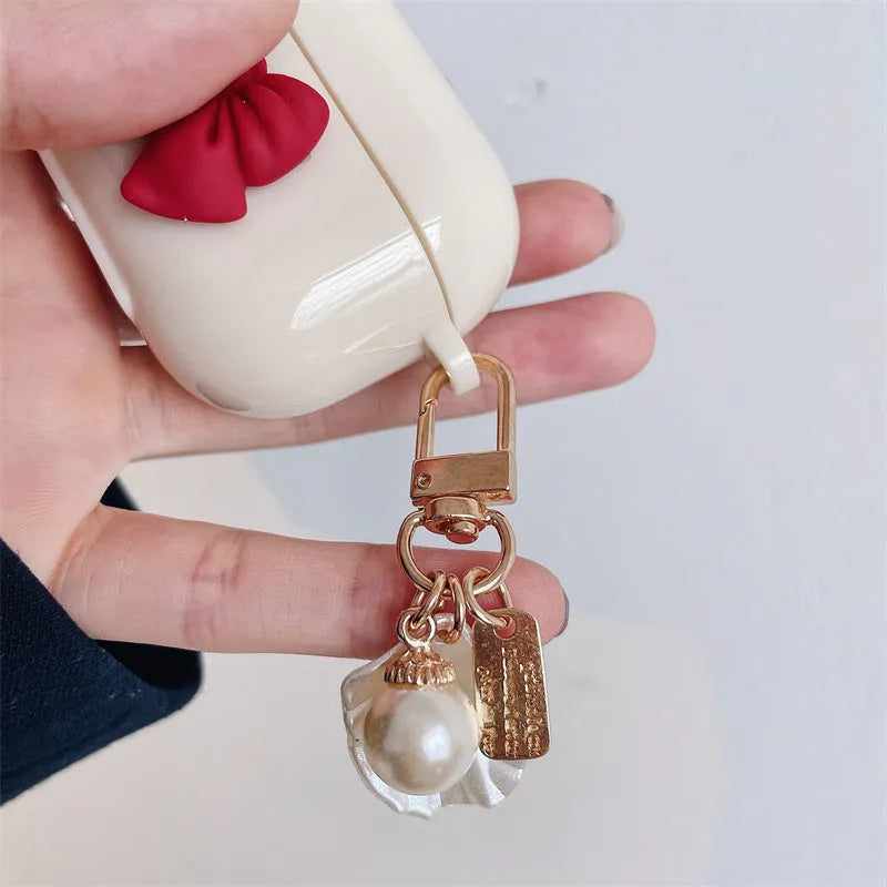 Beige TPU clamshell earphone case with a red bow design for AirPods.