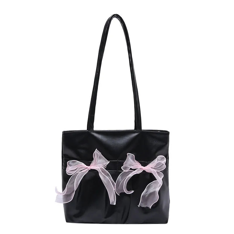 Black PU leather bow tote bag with double shoulder straps, shown with interior zipped pocket.