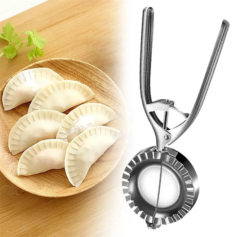 Silver stainless steel manual dumpling press mould with handle on a kitchen worktop.