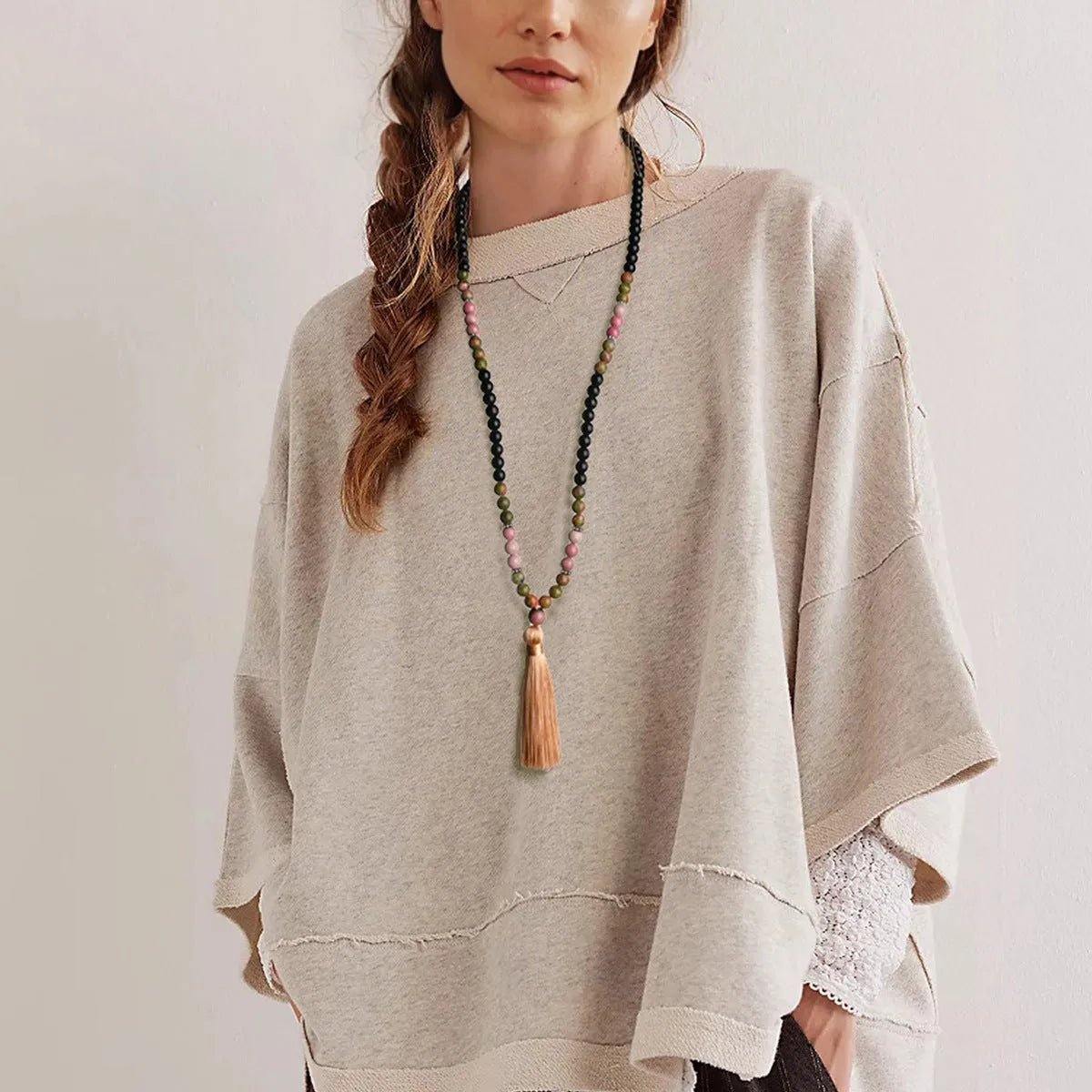 Long beaded bohemian necklace with 108 gemstone tassel pendants on a ball chain.