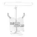 Multifunctional table lamp with adjustable colour temperature and integrated bookshelf on a desk.
