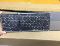 Ultra-thin tri-fold folding touch keyboard in black or silvery white, showing folded and unfolded sizes with touchpad