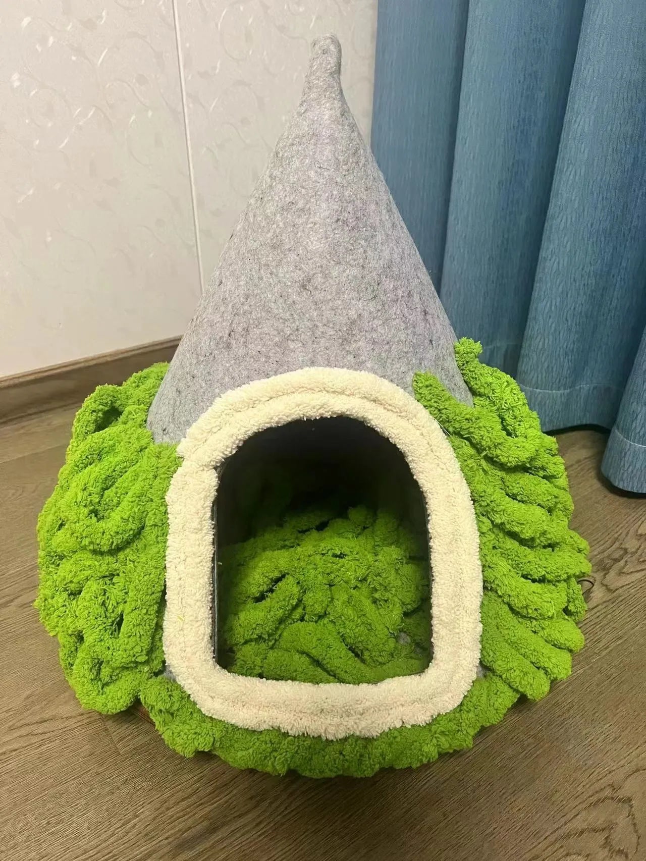 Grey conical felt cat house for indoor cats under 12 pounds.