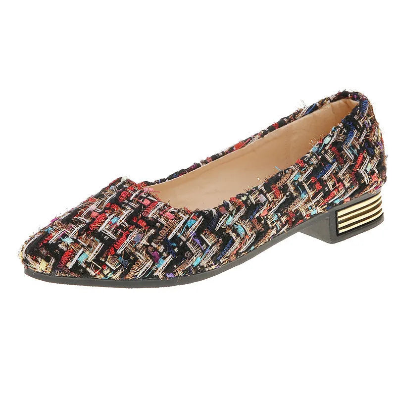 Women's black and white floral patterned canvas casual shoes with a pointed toe and flat rubber sole.