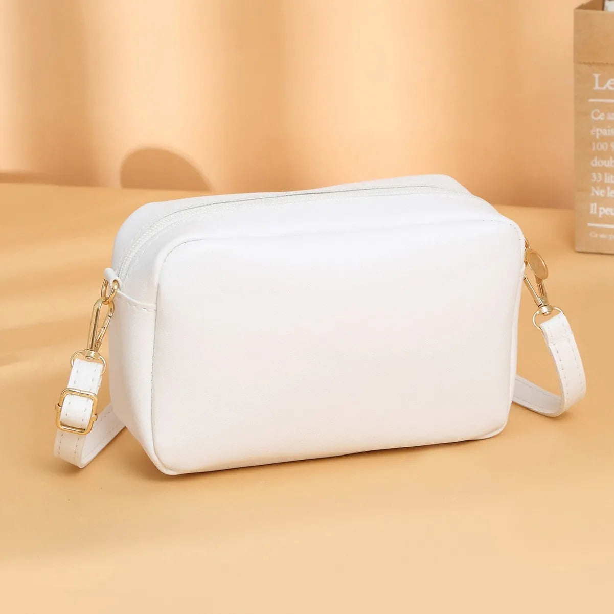 Women's solid colour PU shoulder bag with three-dimensional pocket in orange red, showing horizontal square shape and urban simplicity style