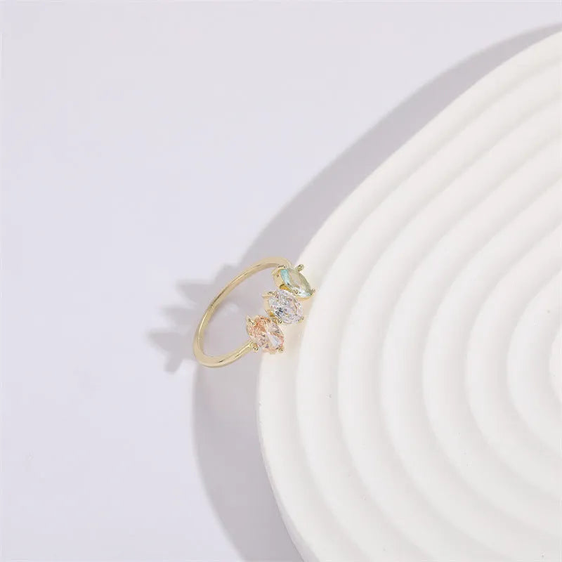 Geometric horse eye ring with tricolour zircon stones on a 14k gold-plated copper band.