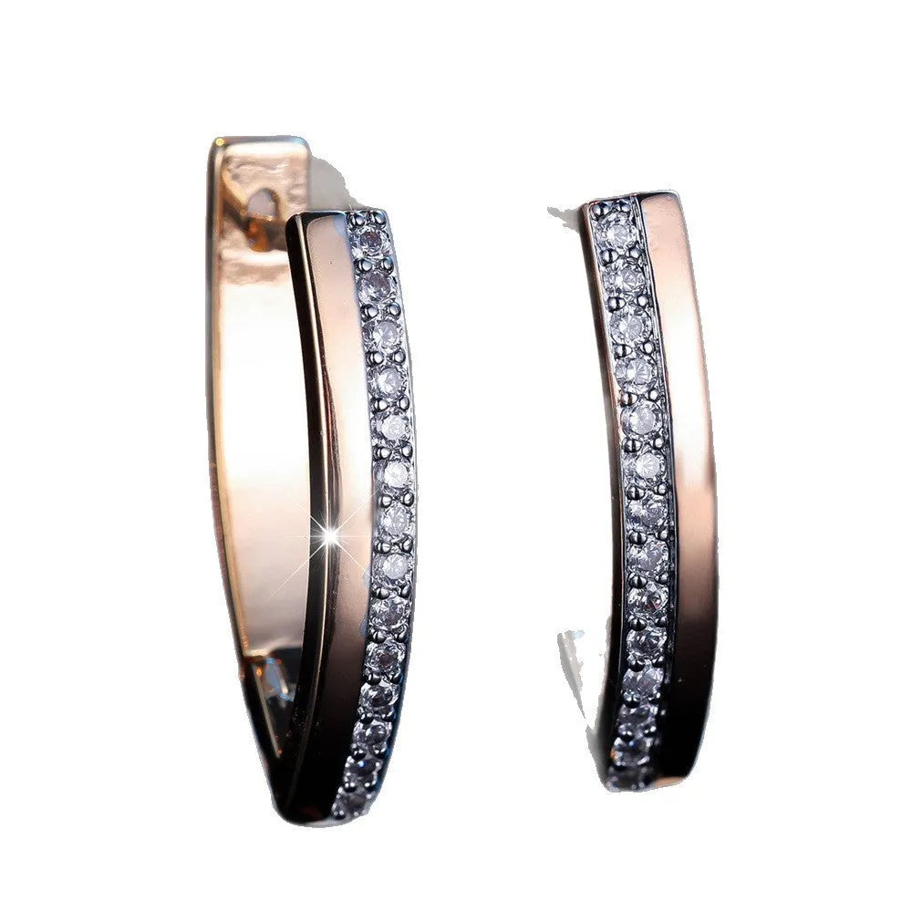 Geometric V-shaped women's ear clips in champagne gold with white diamond accents