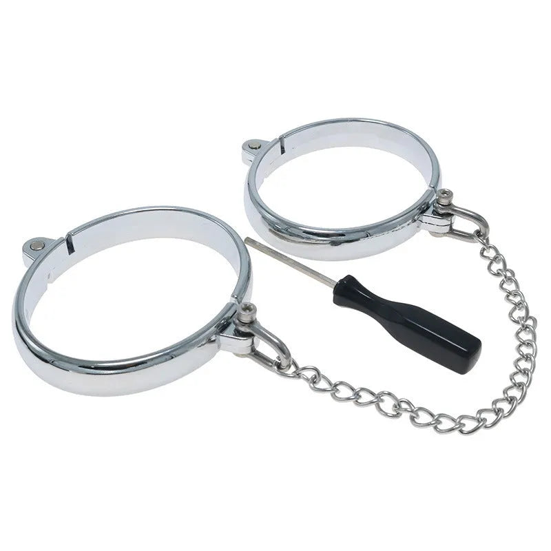 Silver zinc alloy handcuffs and footcuffs set with stainless steel chain linking on black background