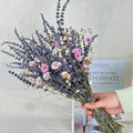 A long dried lavender flower bouquet in a vase, showing white or pink colour options.