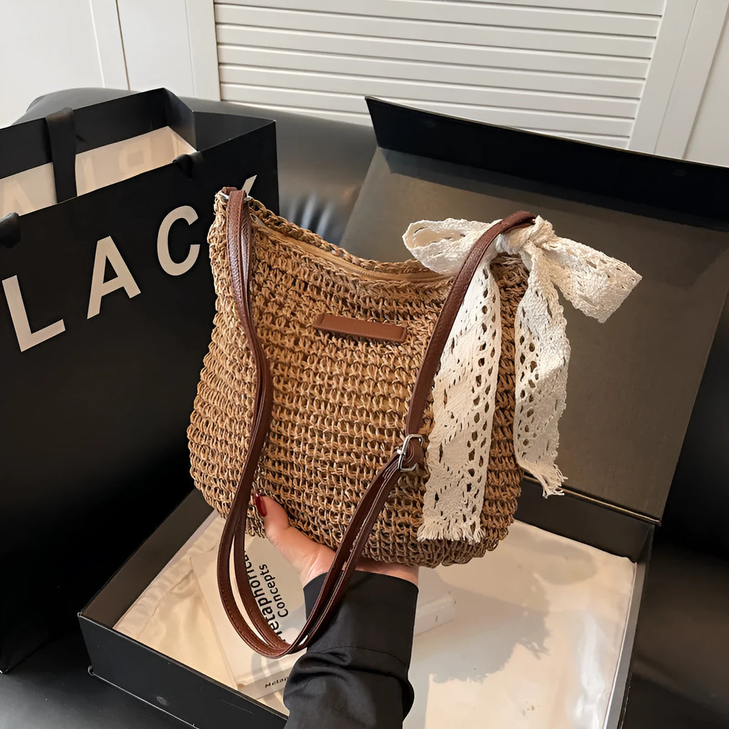 Women's woven straw messenger bag with hollowed design in khaki colour showing vertical square shape and single shoulder strap