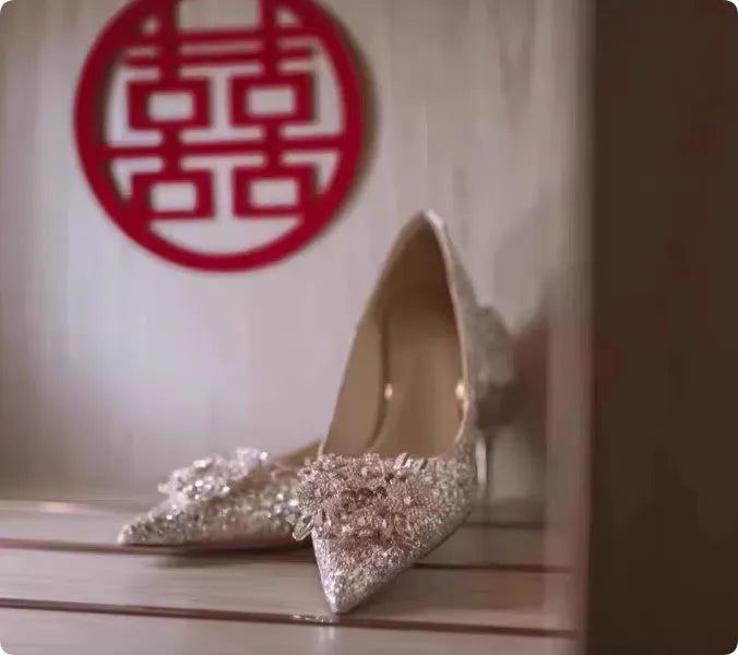 Champagne Xiuhe wedding shoes with rhinestone flower pattern and pointed toe on a fine heel.