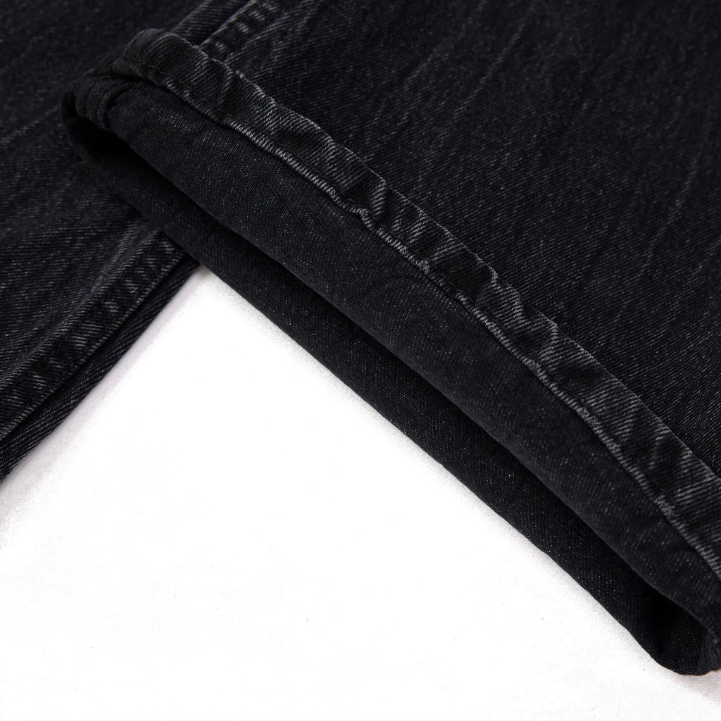 Men's black straight-leg jeans with faded lightning crack pattern on cotton denim