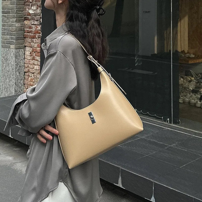 Genuine leather crossbody shoulder bag with dumpling shape, internal organisation pockets, and street trend style details
