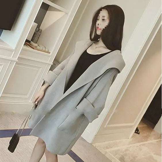Plus size woman wearing a grey thin cotton coat with lace trim detail and long sleeves.