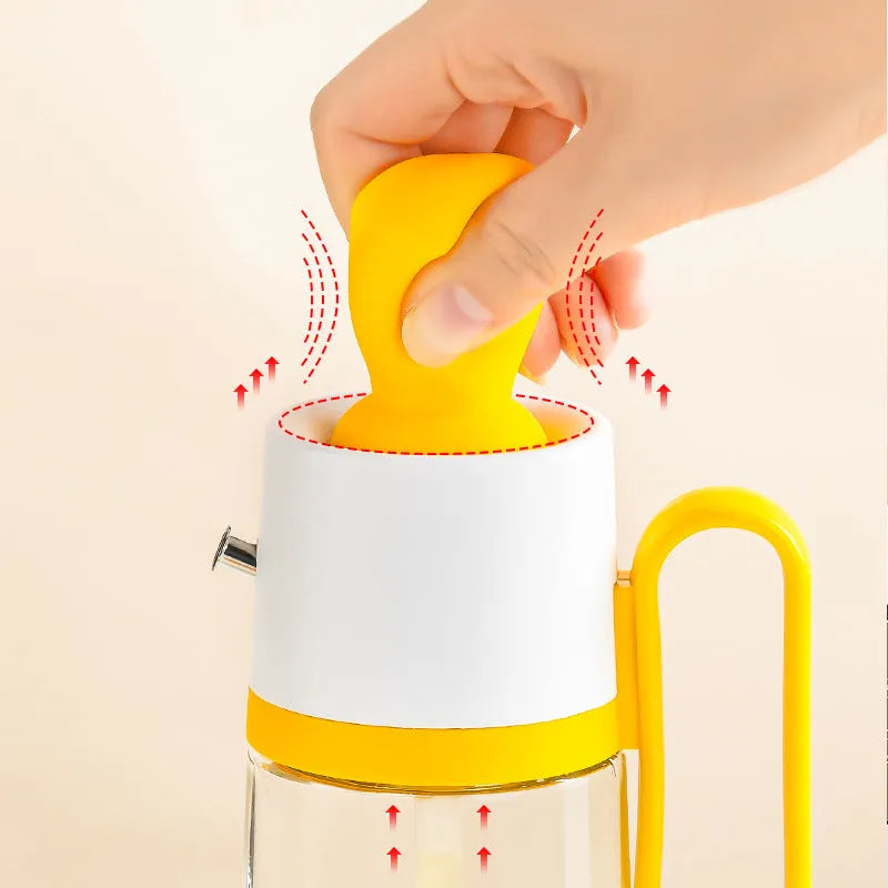 Yellow, green, and brown 550ml glass oil dispenser with silicone brush and stainless steel nozzle.
