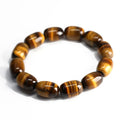 Close-up of a natural yellow Tiger Eye gemstone beaded bracelet with cat's eye effect on a wrist.