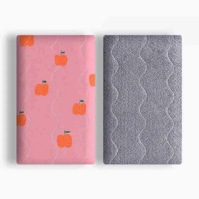 Colourful double-sided cotton pet blanket with dinosaur print, shown next to a dog bed.