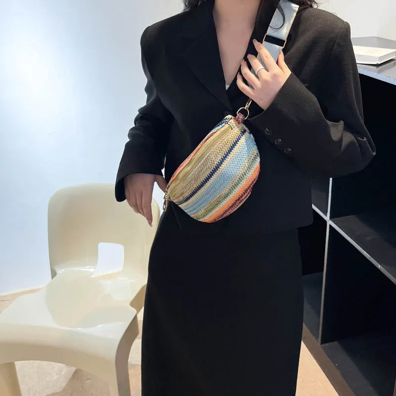 Blue straw woven women's shoulder bag with shell shape and single strap showing sandwich pocket detail