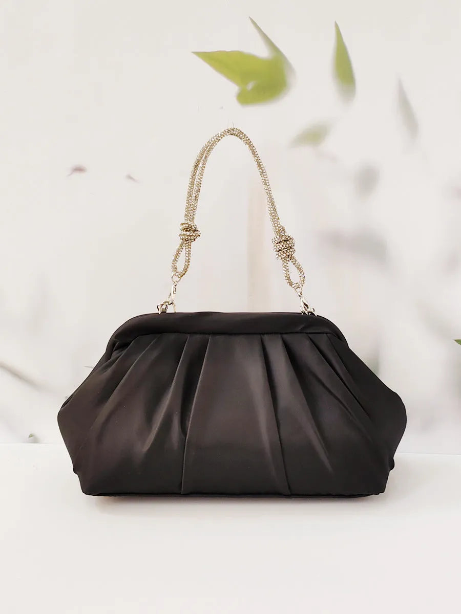 Women's black shoulder messenger bag with document compartment, soft polyester material, and chain decorative details