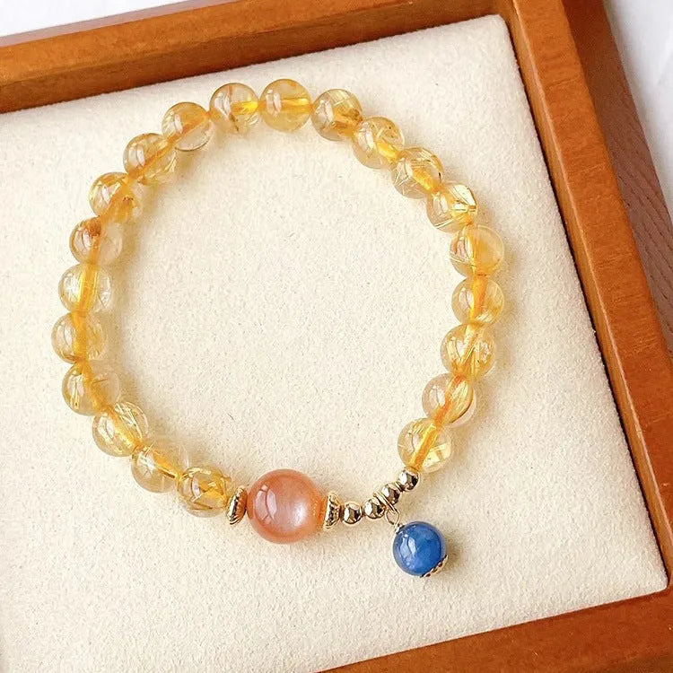 Women's gold rutilated quartz and sunstone crystal bracelet with round beads on elasticated band