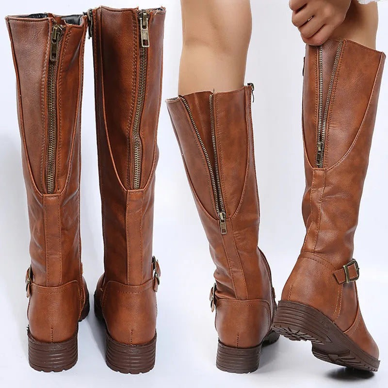 Women's black knight high boots with a square heel and a front belt buckle detail on a round toe.