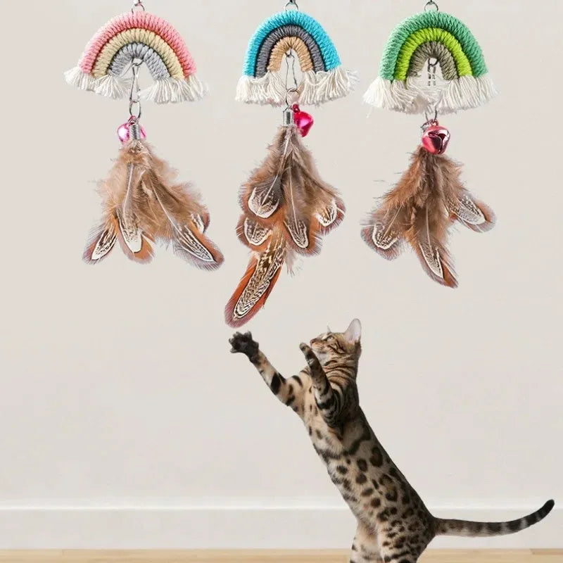 Blue feather cat rope hanging from a door on an elastic swing with a sticky buckle clamp.