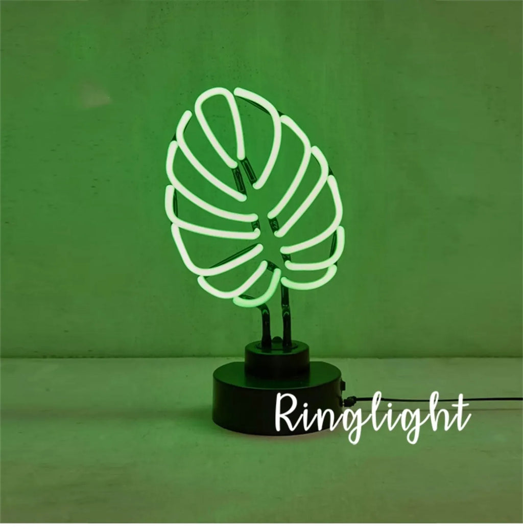 White bamboo-shaped desktop lamp with green light, USB cable, and minimalist design on wooden desk