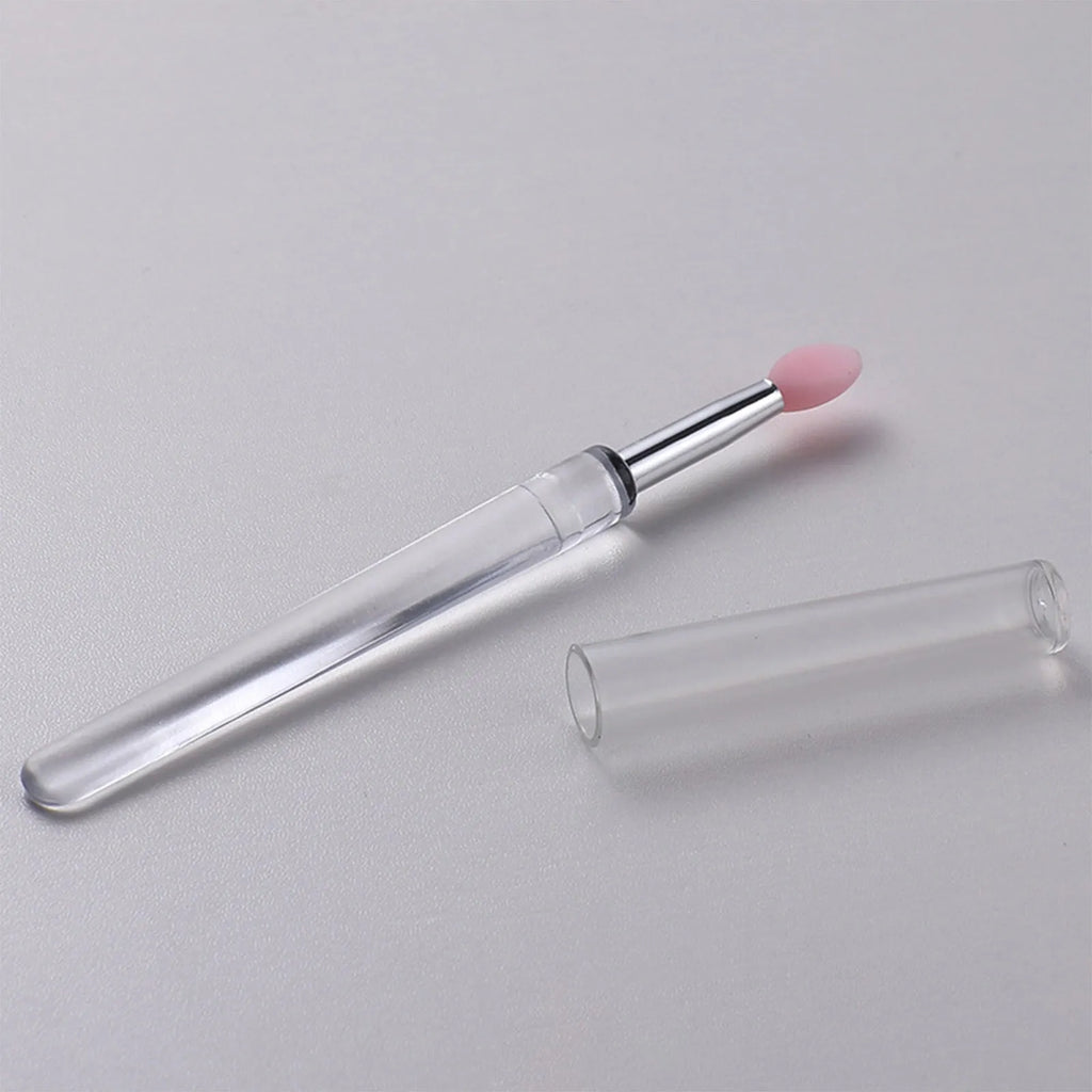 Set of reusable silicone lip brushes with caps in eight different colours on a white background.