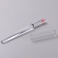 Set of reusable silicone lip brushes with caps in eight different colours on a white background.