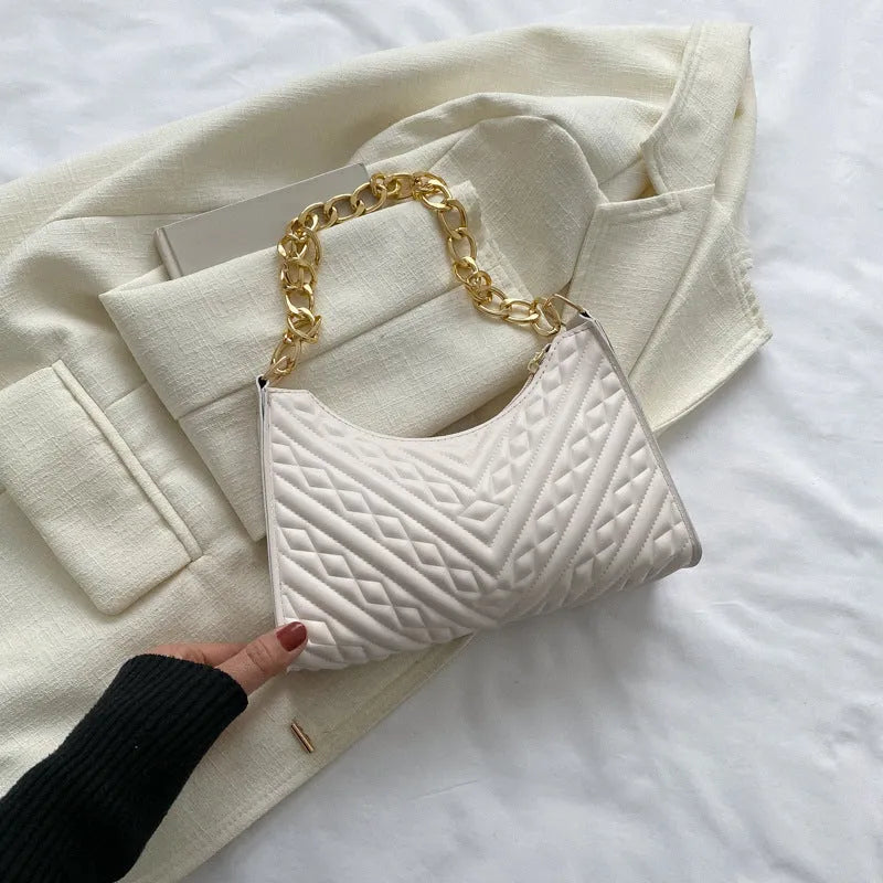 Brown pleated chain baguette shoulder bag with adjustable strap and soft carry handle showing three-dimensional pocket design