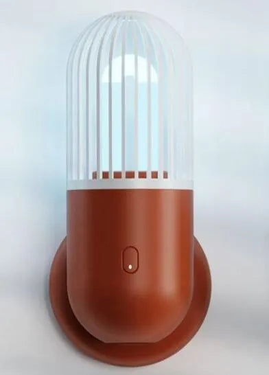 Compact portable UVC disinfection lamp in capsule design showing black, brown, green, and white colour options.