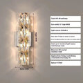 A sleek crystal wall lamp with a stainless steel base in chrome finish, mounted on a wall.
