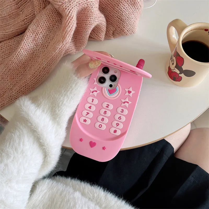 Flip phone shape mirror case for iPhone with silicone construction in light pink colour showing integrated mirror and flip cover design