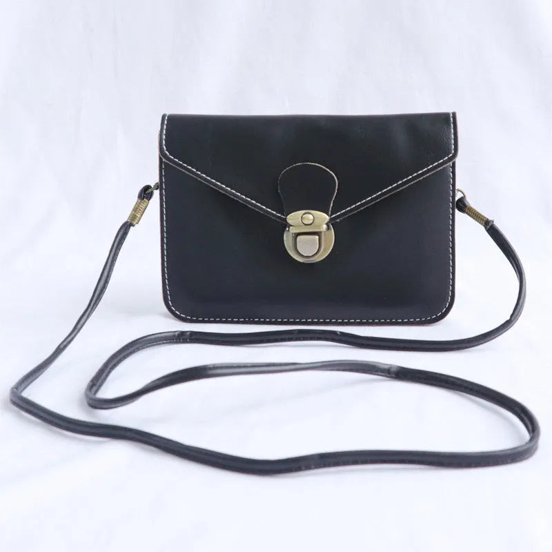 Retro soft-surface crossbody messenger bag with flap closure and lock detail in wine red colour