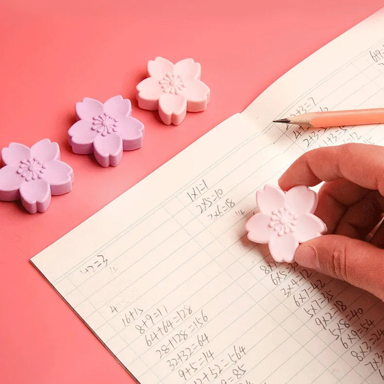 Pack of cherry blossom design student erasers on a desk, shown to leave no marks or debris.