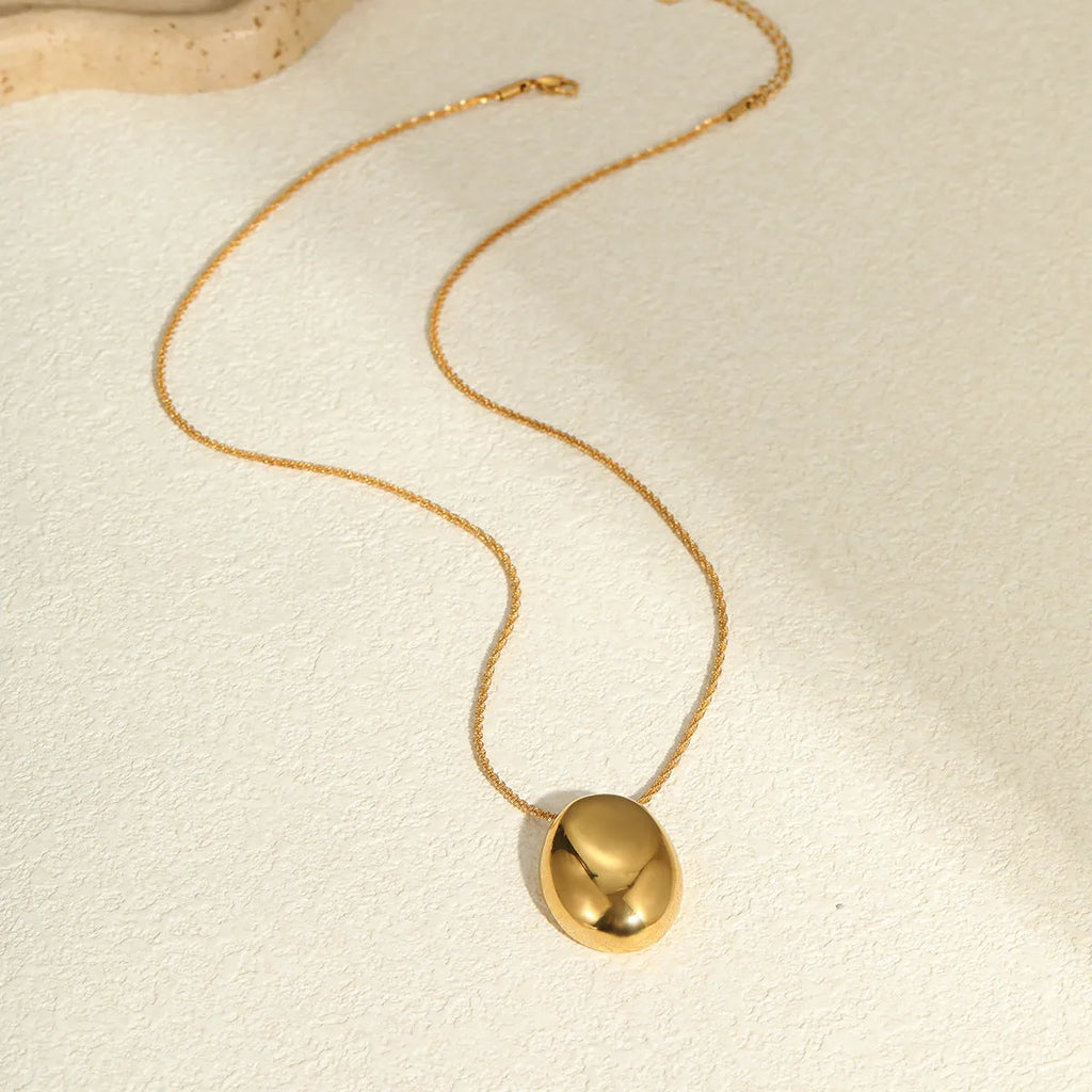 Long gold-plated necklace featuring a geometric pendant on an adjustable stainless steel chain.