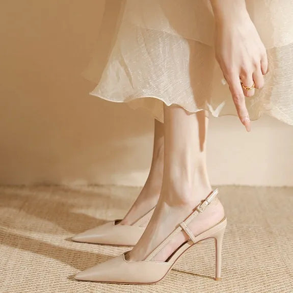 Apricot women's high-heeled sandals with a single thin strap and buckle fastening, shown on a foot.