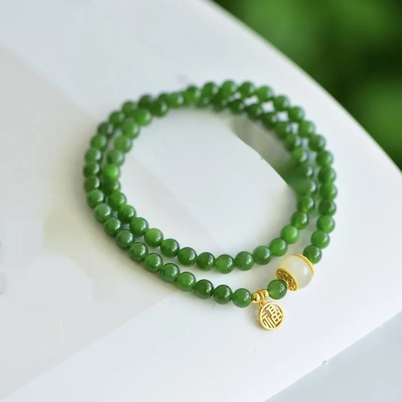 Women's double circle bracelet with natural Hetian jade beads and a central fu character charm.