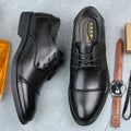 Men's black leather lace-up shoe with decorative stitching and a horse buckle on a rubber sole.