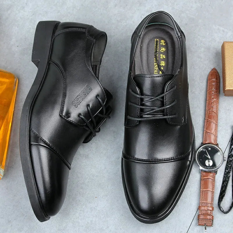 Men's black leather lace-up shoe with decorative stitching and a horse buckle on a rubber sole.
